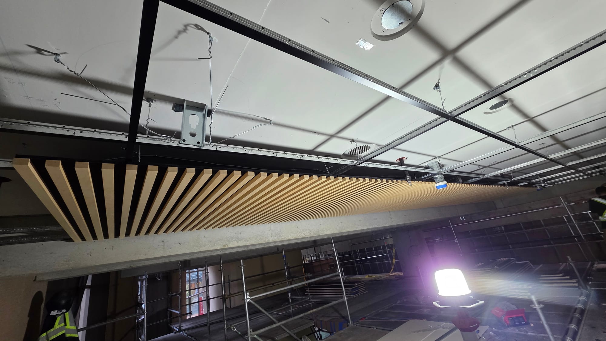 Suspended wood slat ceiling installed by Rambo Walls and Ceilings
